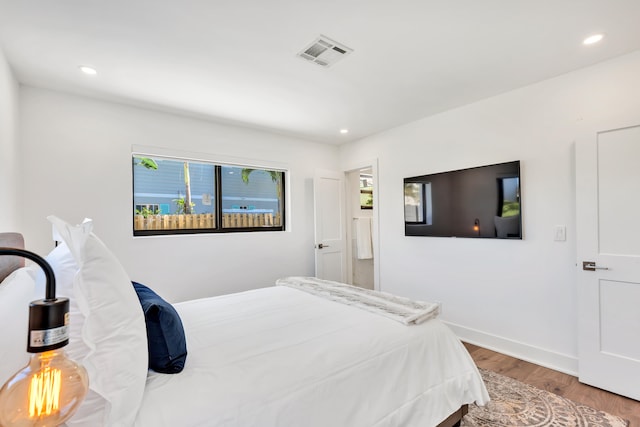 bedroom with hardwood / wood-style flooring