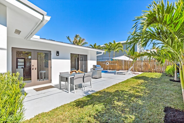 view of yard with french doors and a patio area