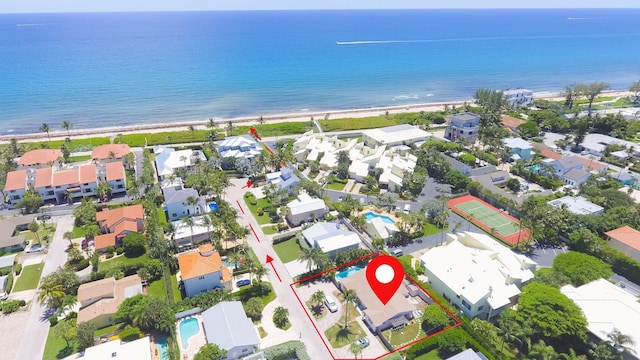 aerial view with a water view and a beach view