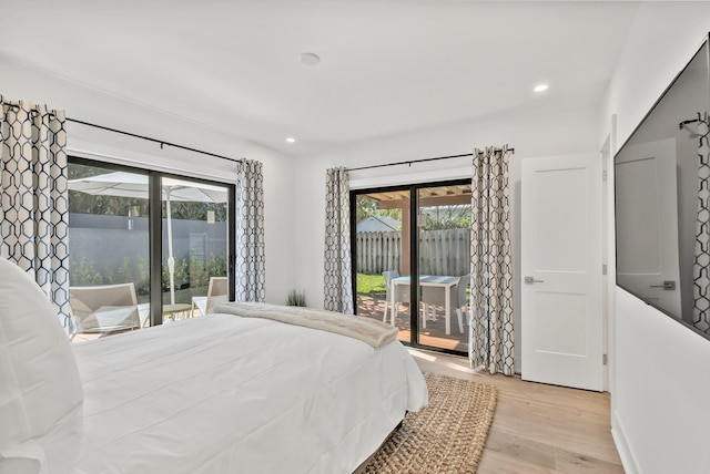 bedroom with light hardwood / wood-style flooring and access to outside