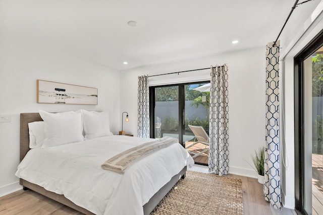 bedroom featuring access to outside and light wood-type flooring