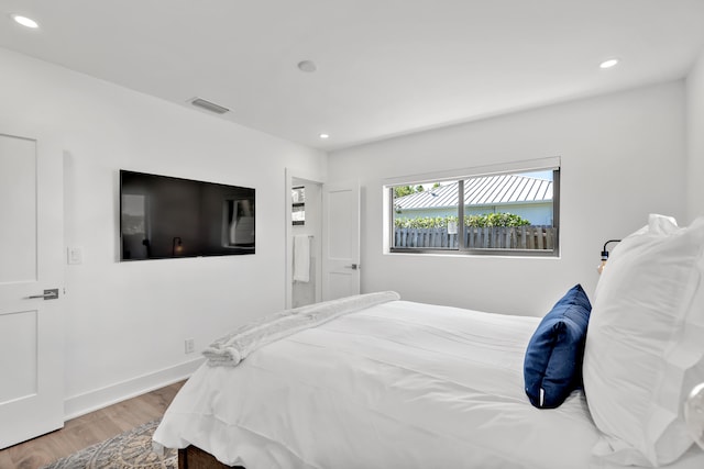 bedroom with hardwood / wood-style flooring