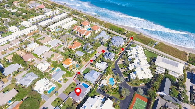 birds eye view of property with a view of the beach and a water view