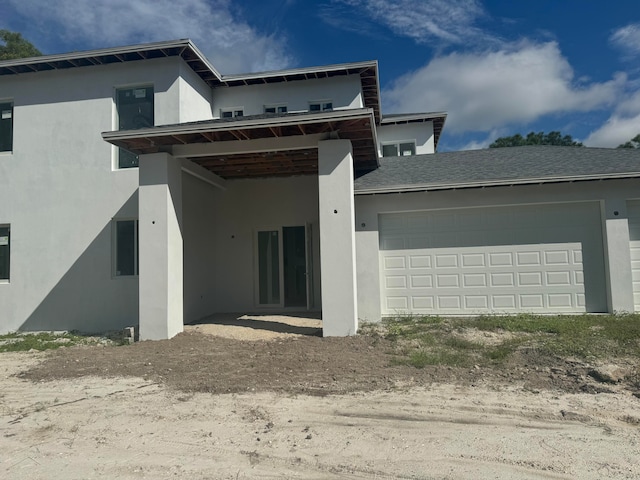 back of property with a garage