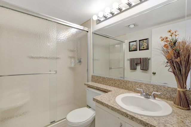 bathroom with vanity, toilet, and an enclosed shower