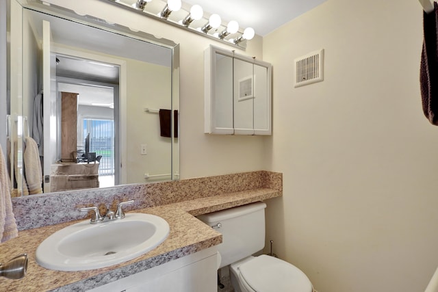 bathroom featuring vanity and toilet