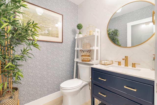 bathroom featuring toilet and vanity