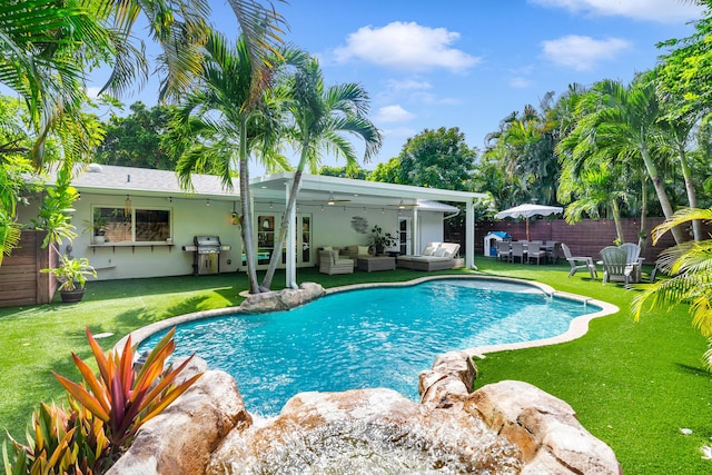 view of swimming pool featuring an outdoor living space, a grill, a patio area, and a yard