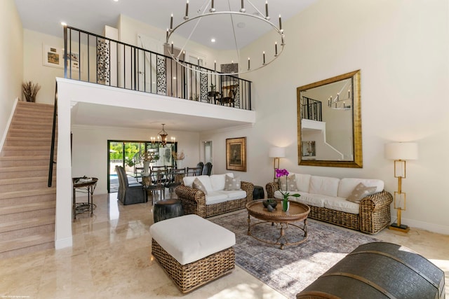 living room with crown molding, a towering ceiling, and an inviting chandelier