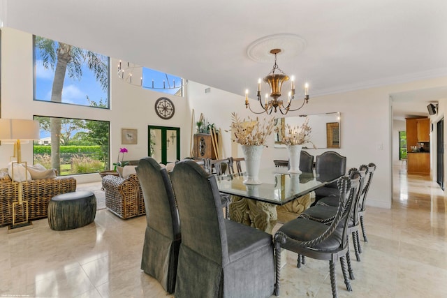 dining area with light tile patterned flooring, a chandelier, and ornamental molding