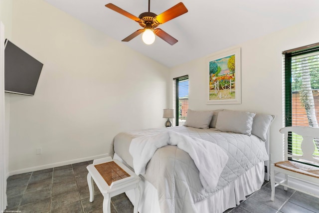 bedroom with lofted ceiling, multiple windows, and ceiling fan