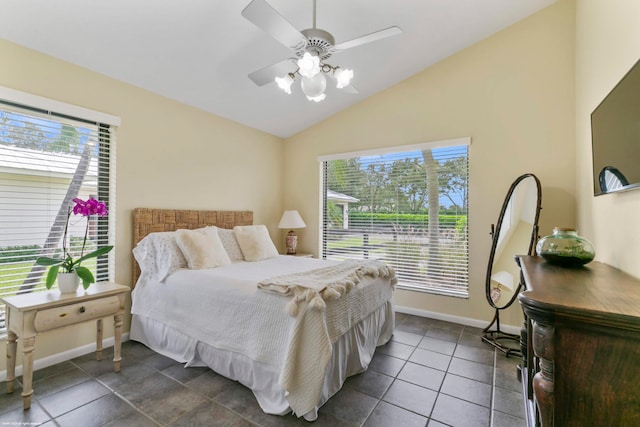 tiled bedroom featuring ceiling fan, lofted ceiling, and multiple windows