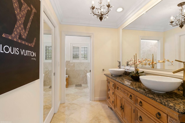 bathroom featuring crown molding, vanity, and an inviting chandelier