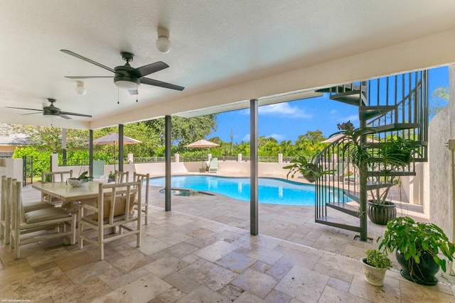 view of swimming pool with a patio and ceiling fan