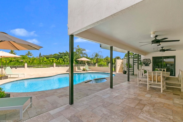 view of swimming pool featuring ceiling fan and a patio area