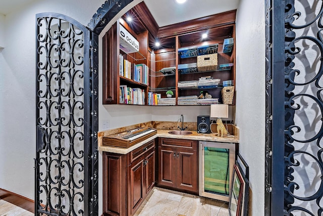 wine area featuring light hardwood / wood-style floors, wine cooler, and wet bar