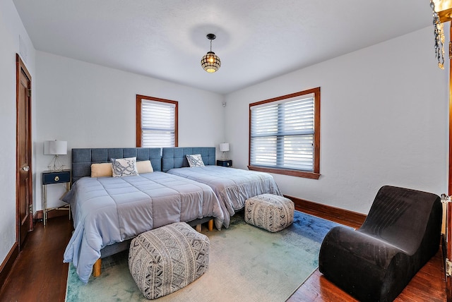 bedroom with wood-type flooring and multiple windows