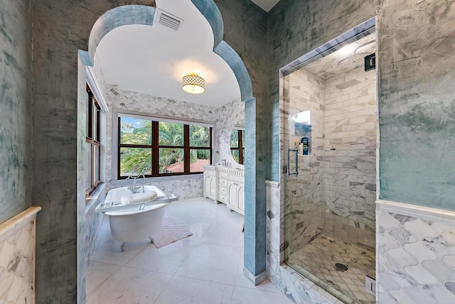 bathroom featuring vanity, shower with separate bathtub, and tile walls