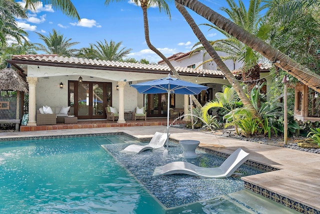 view of pool featuring a patio, french doors, and a water slide