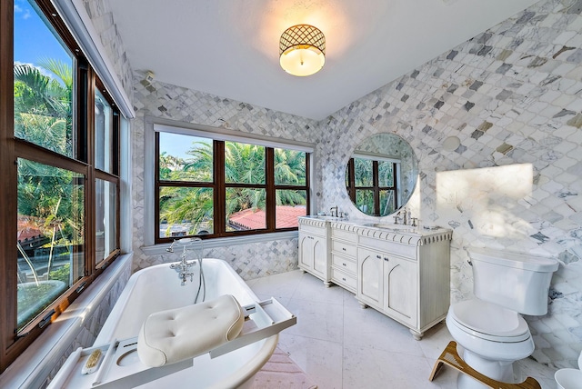 bathroom featuring vanity, a bathing tub, and tile walls