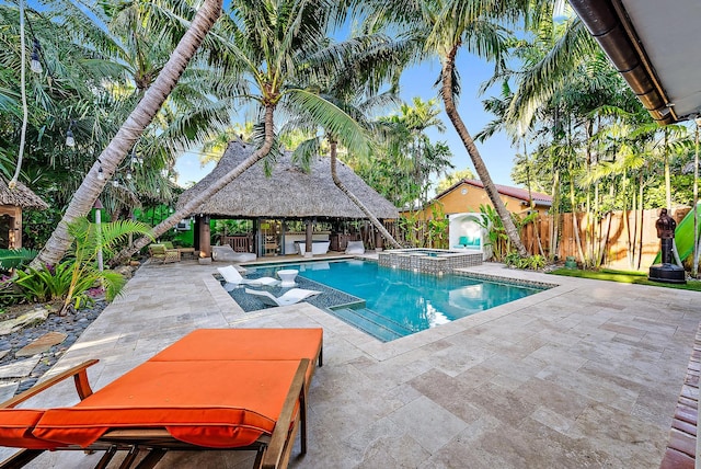 view of swimming pool featuring a patio, an in ground hot tub, and a gazebo