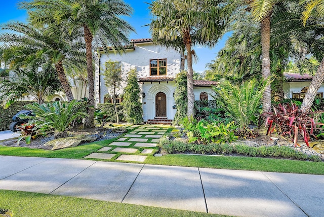 mediterranean / spanish home with a front yard