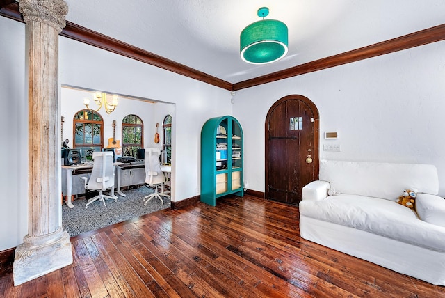 foyer entrance featuring dark wood-type flooring, decorative columns, and ornamental molding