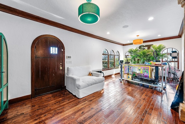 entryway featuring hardwood / wood-style floors, a textured ceiling, and crown molding