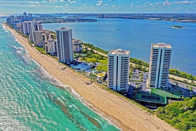 aerial view with a water view and a beach view