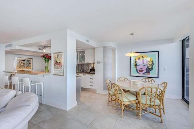 dining area with light tile patterned floors