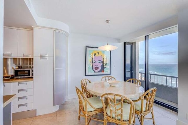 tiled dining space with a water view