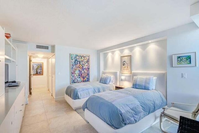 bedroom with light tile patterned floors