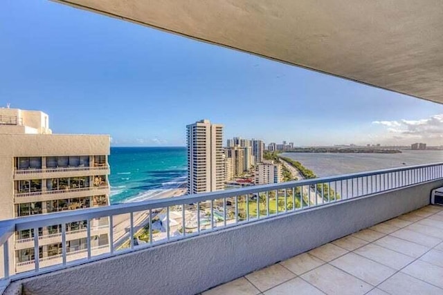 balcony featuring a water view and a beach view