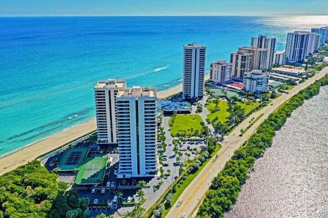 birds eye view of property featuring a water view and a beach view