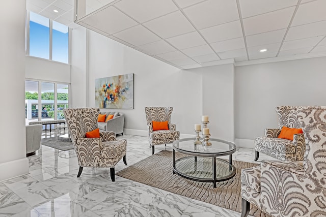 sitting room featuring a drop ceiling