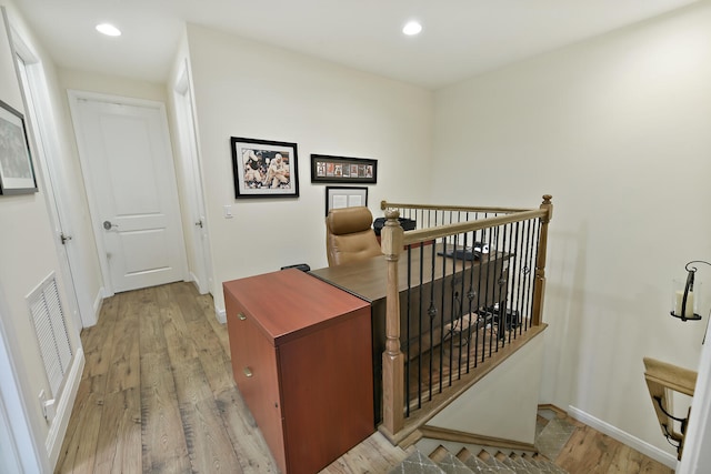 stairway with hardwood / wood-style flooring