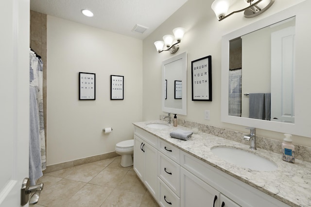 bathroom featuring tile patterned flooring, walk in shower, vanity, and toilet