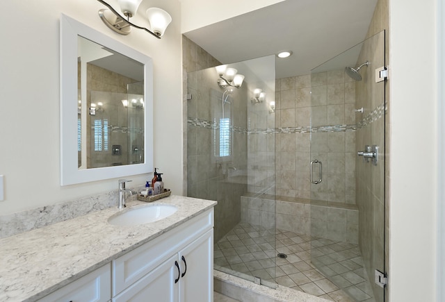 bathroom featuring vanity and a shower with shower door