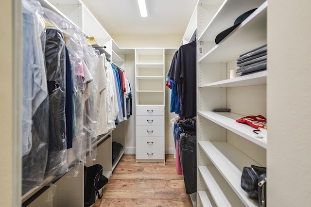 walk in closet with light wood-type flooring