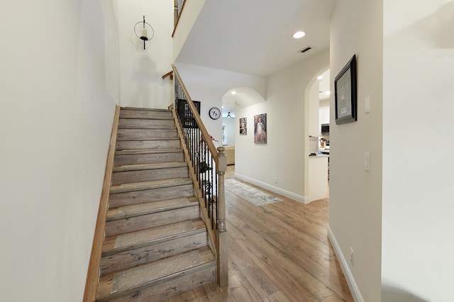 staircase featuring wood-type flooring