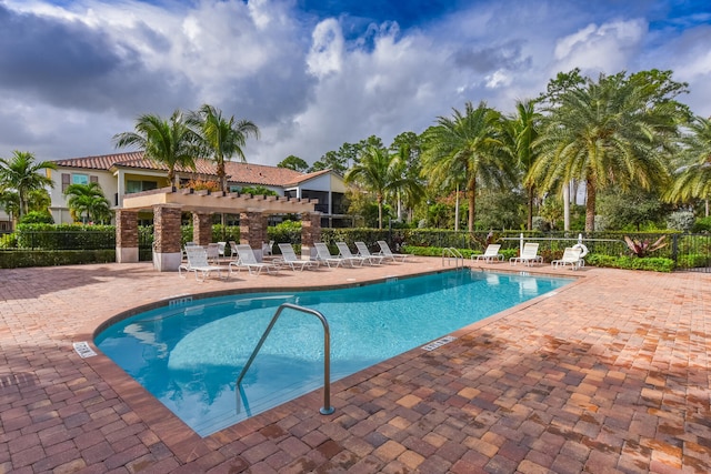 view of pool with a pergola and a patio