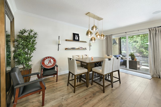 dining area with a notable chandelier, light wood-type flooring, crown molding, and a textured ceiling