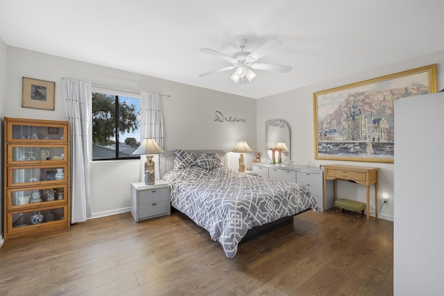 bedroom with dark hardwood / wood-style flooring and ceiling fan