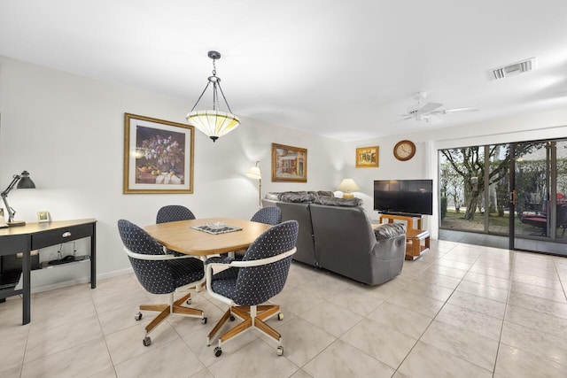 tiled dining space featuring ceiling fan