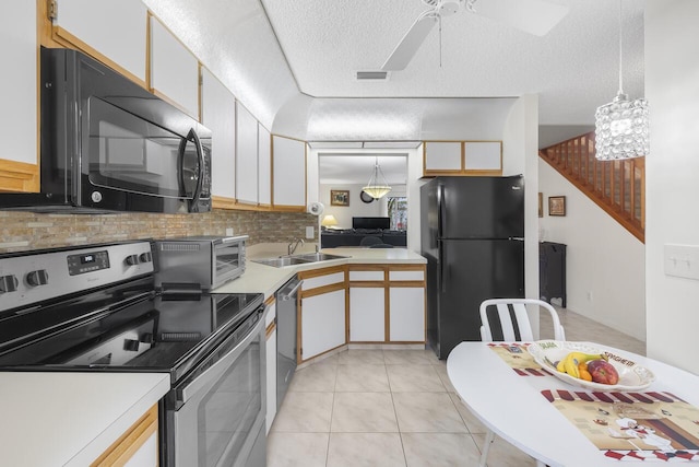 kitchen with sink, white cabinetry, black appliances, a textured ceiling, and decorative light fixtures