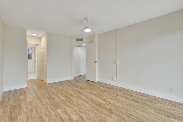 empty room featuring ceiling fan and light hardwood / wood-style flooring