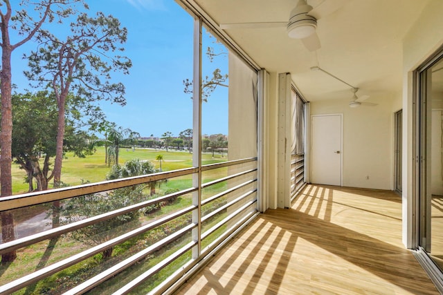 unfurnished sunroom with ceiling fan