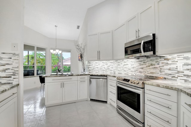 kitchen with vaulted ceiling, a chandelier, stainless steel appliances, and white cabinetry