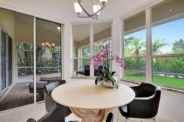 sunroom / solarium featuring a notable chandelier