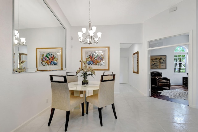 dining space featuring a notable chandelier and light wood-type flooring